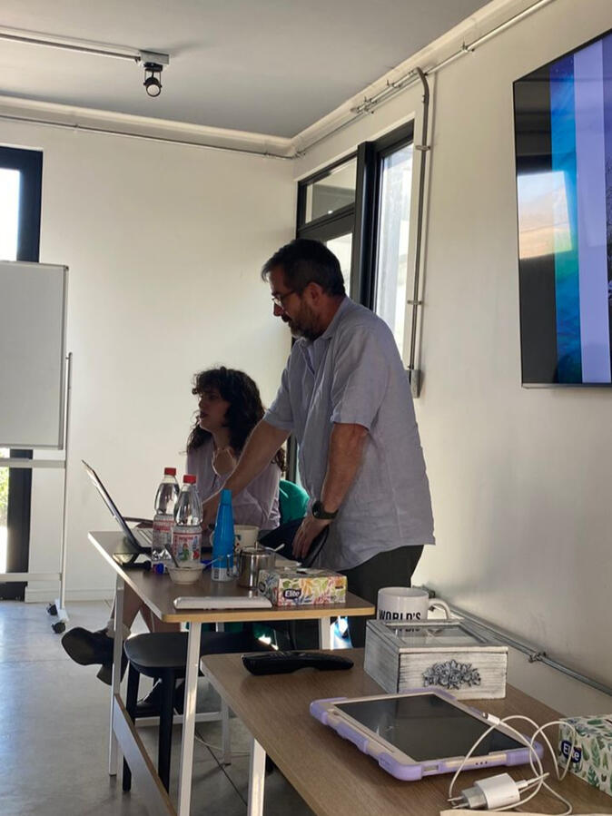 Eloisa Ojeda providing consecutive interpreting with the speaker on her side